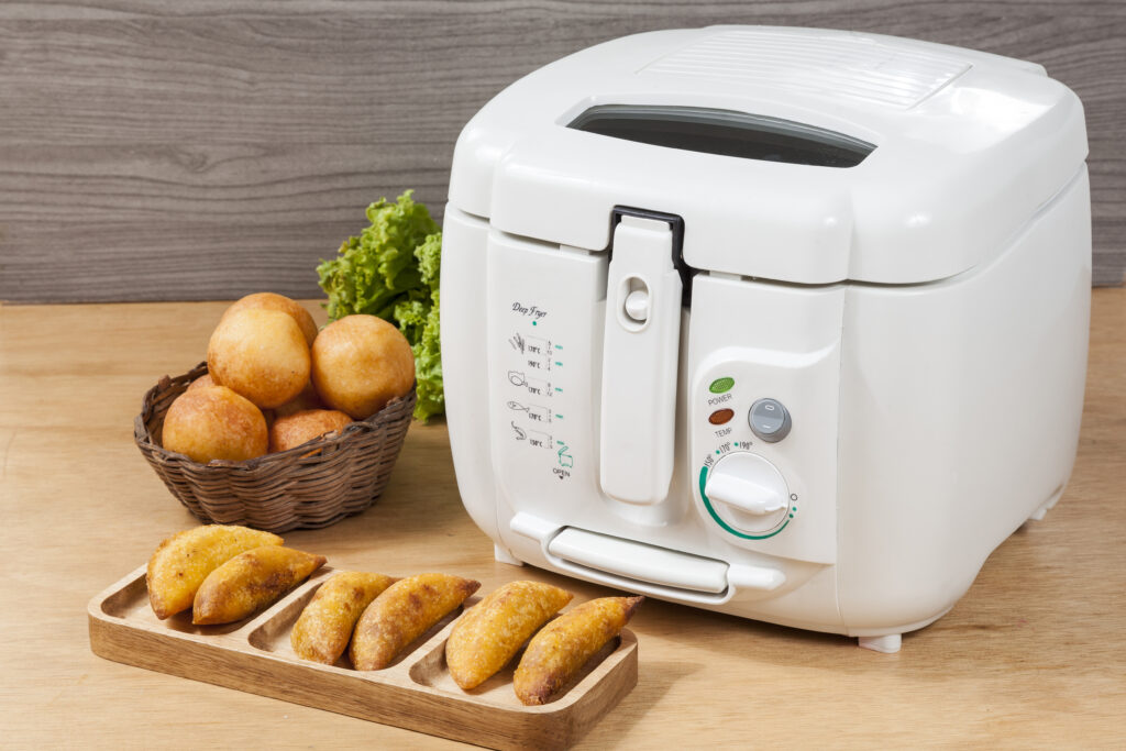 Household kitchen - A white automatic electric fryer pot.